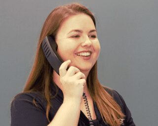 A photo of Latisha Ryder over a phone call while smiling. - Ryder Machining Specialists A photo of Latisha Ryder over a phone call while smiling. - Ryder Machining Specialists