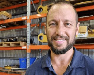 A photo of Brock Ryder, has a semi-bald haircurt and smiles at the camera. - Ryder Machining Specialists A photo of Brock Ryder, has a semi-bald haircurt and smiles at the camera. - Ryder Machining Specialists